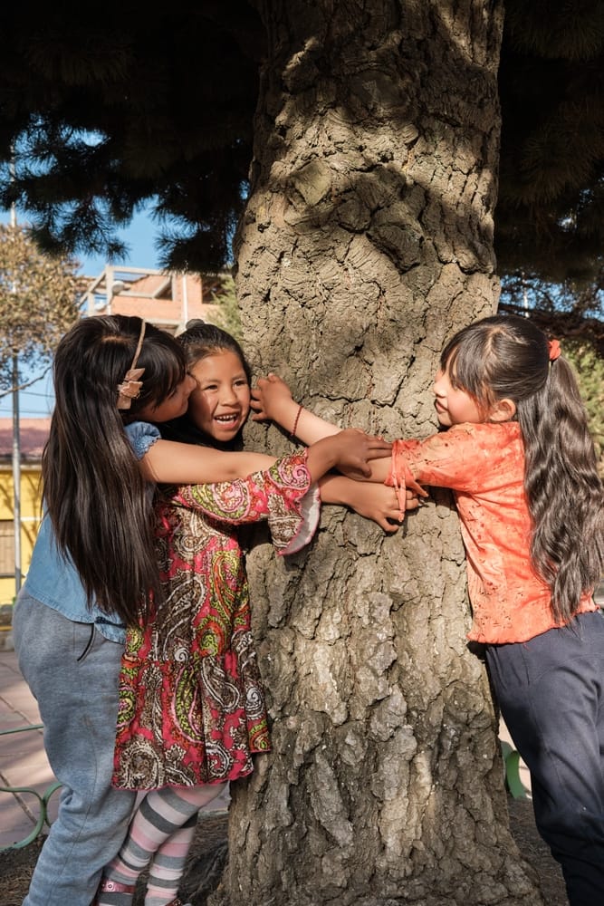 Vertical,Photo,Of,Three,Orphaned,Latin,Girls,Playing,With,A