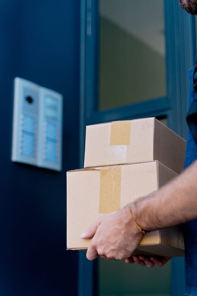 Close,Up,Of,Delivery,Man,Delivering,Parcel,Box.,Courier,Service