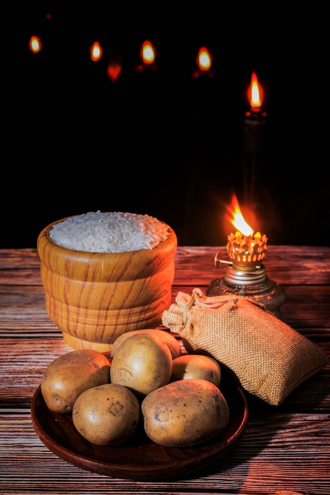 Rice,In,Wooden,Bowl,And,Potatoes,With,Oil,Lamp,At